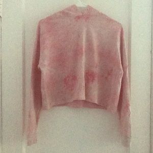 A pink crop top with long sleeves with hoddie